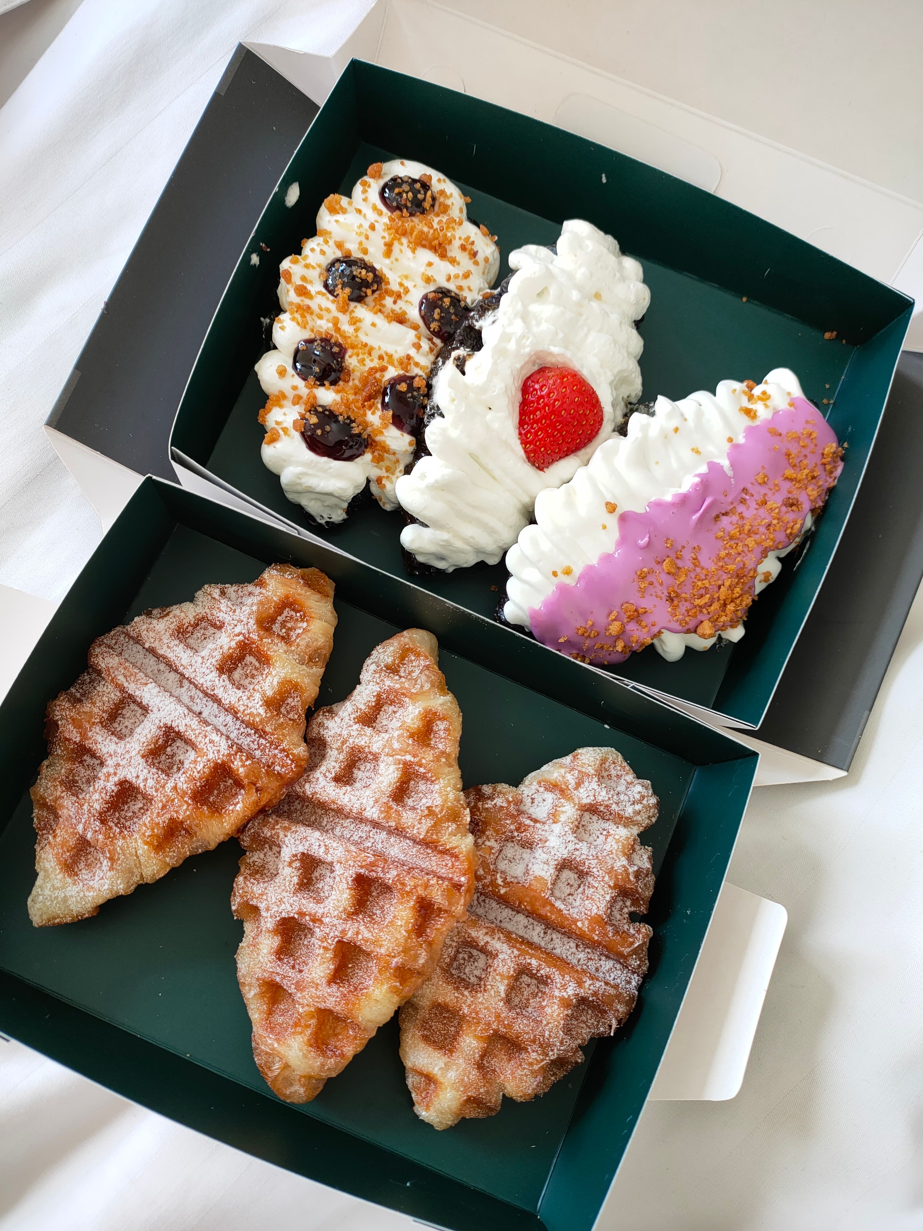 A box of Dessert Dock waffles and cream-topped desserts